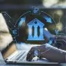 Close up of hands using laptop and smartphone on desktop with abstract online banking hologram on blurry background. Money, technology and trade concept. Double exposure